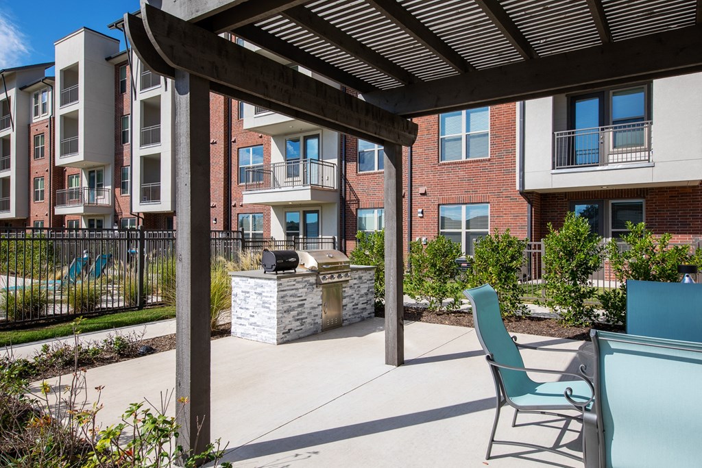 our apartments have a large patio with a grill and chairs