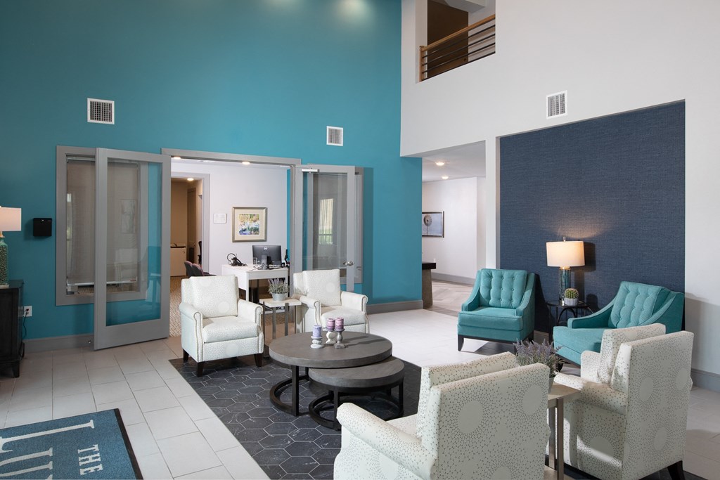 a living room with blue and white furniture and a blue wall