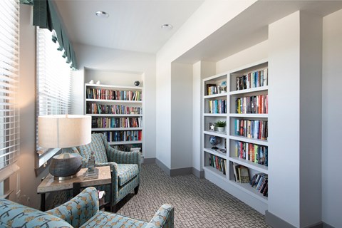 a library with a sitting area at a senior apartment community