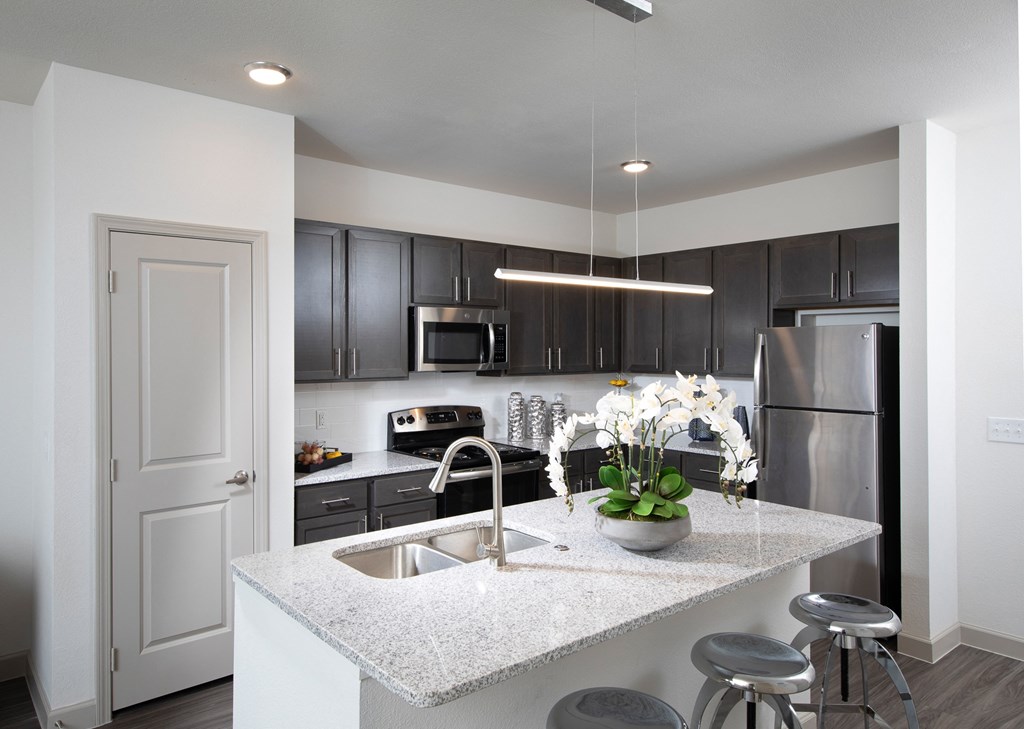 a kitchen with granite counter tops and stainless steel appliances