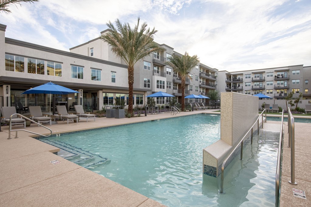 a swimming pool with a building in the background
