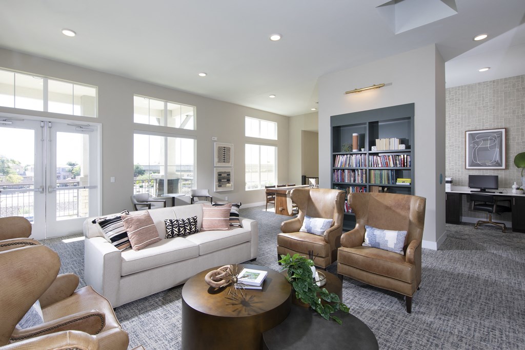 a living room with couches and chairs and a table