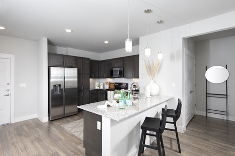 a kitchen with stainless steel appliances and a marble counter top