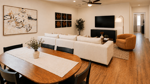 A living room with a white couch and a wooden table.