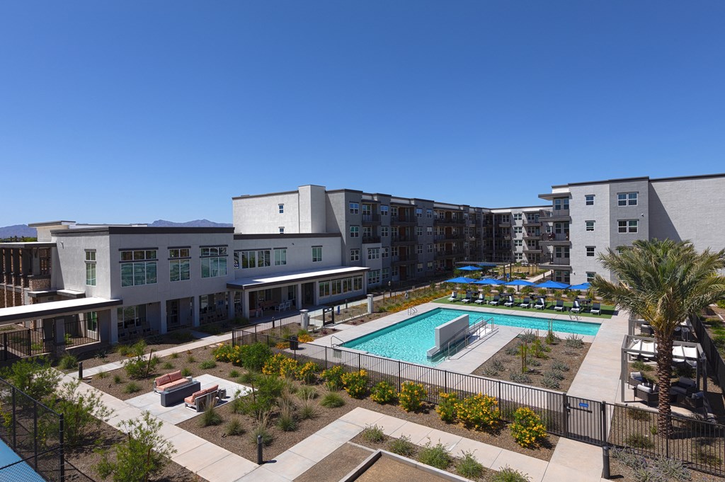 an aerial view of a resort-style pool and courtyard at a senior apartment community