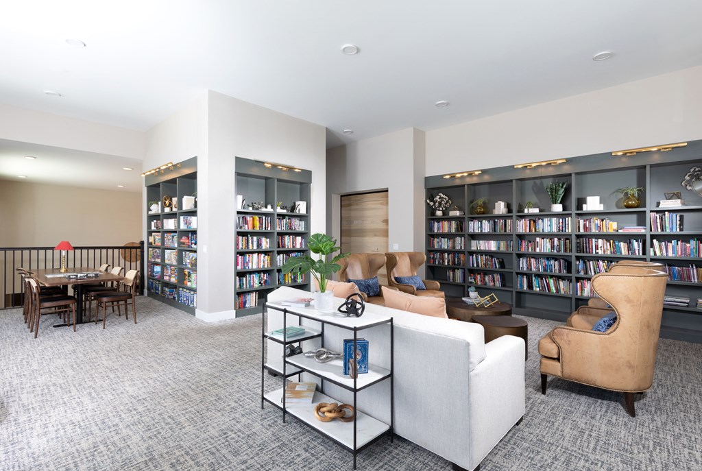 a library with sitting areas at a senior apartment community