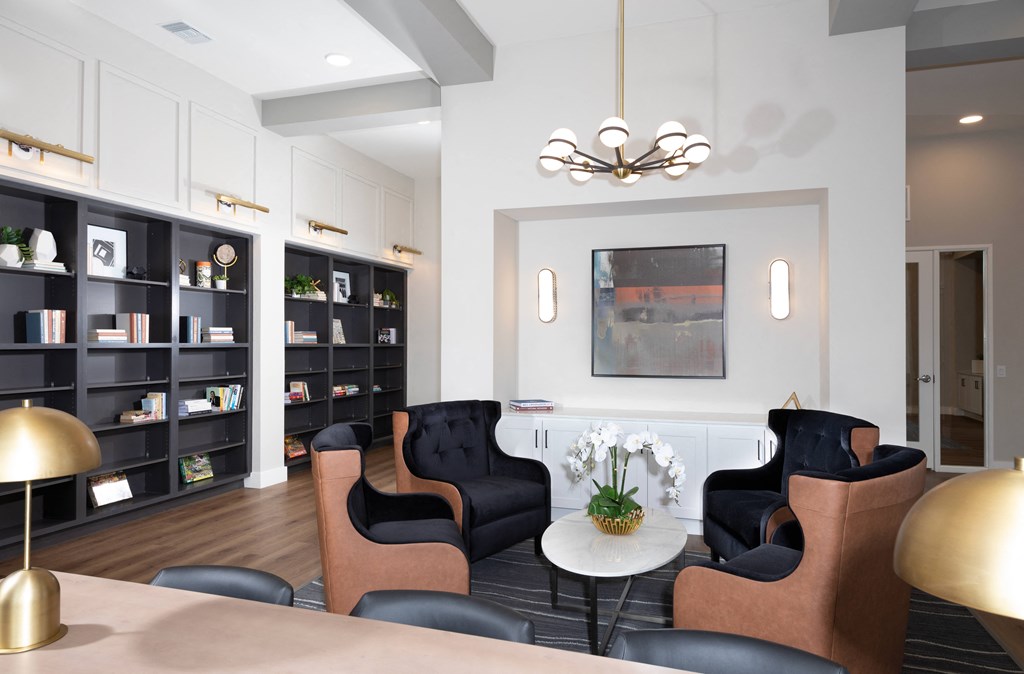 a library with sitting areas at a senior apartment community