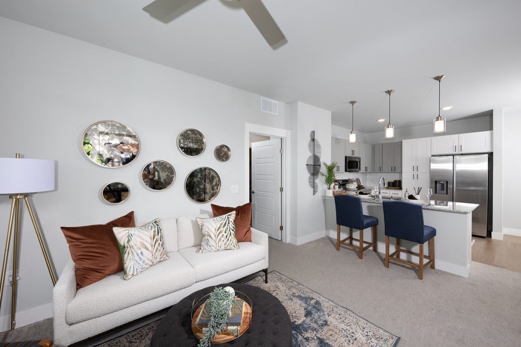 a living room opening up to a kitchen at a senior apartment community