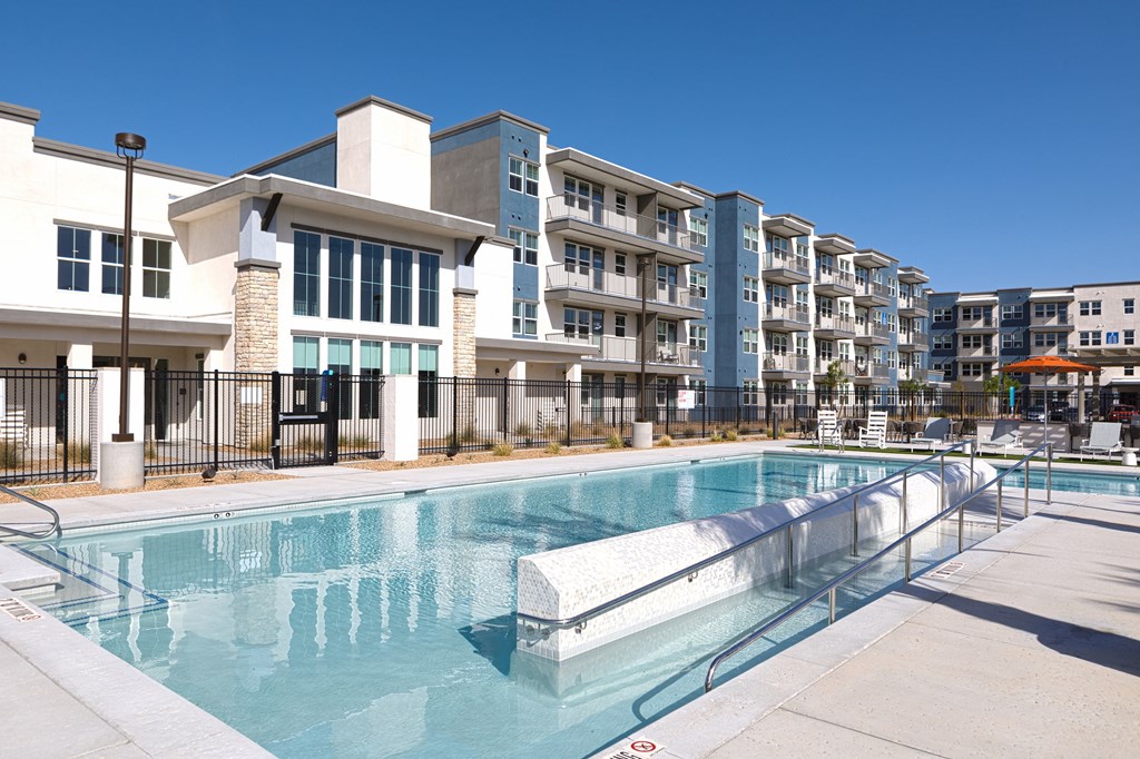 a resort-style pool with railing at a senior apartment community