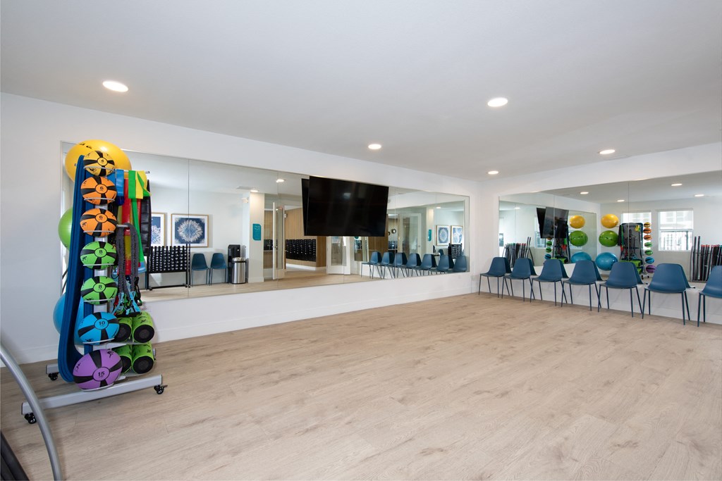 a large room with chairs and a television in the corner