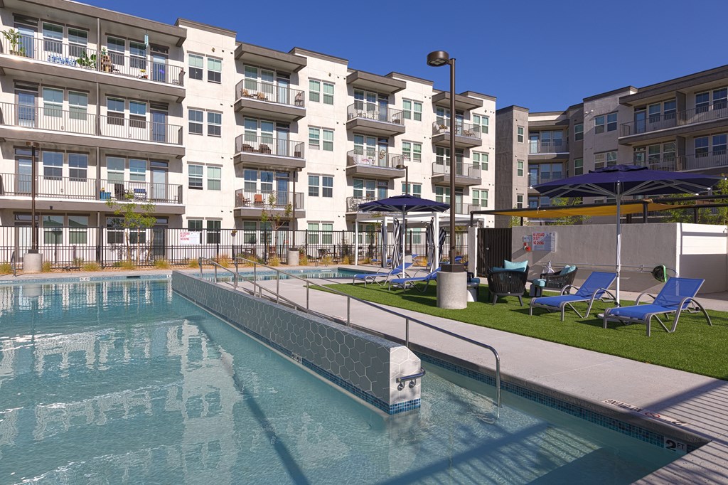 a swimming pool in front of an apartment building