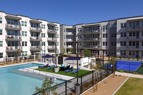 a resort-style pool and lounge area, and pickleball court at a senior apartment community