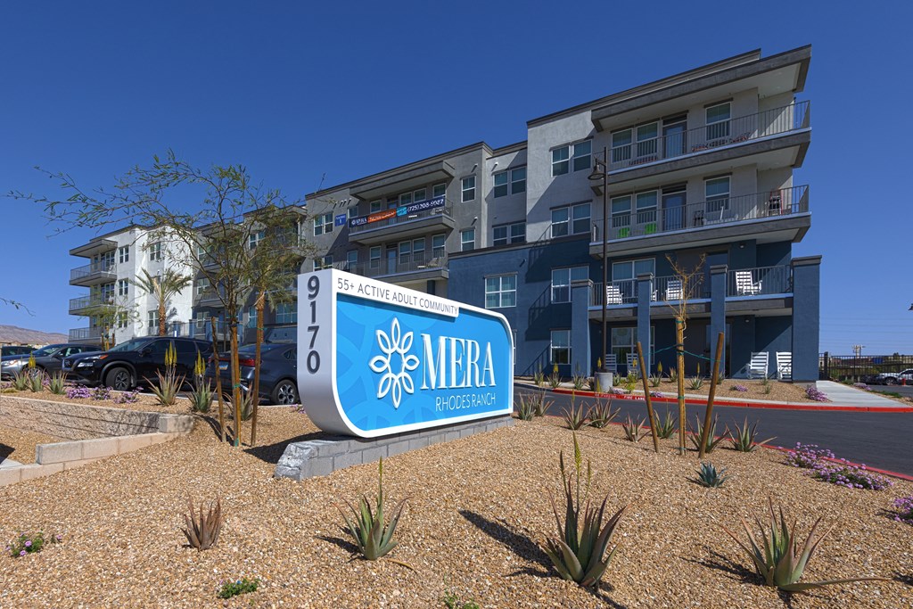 a large sign in front of an apartment building