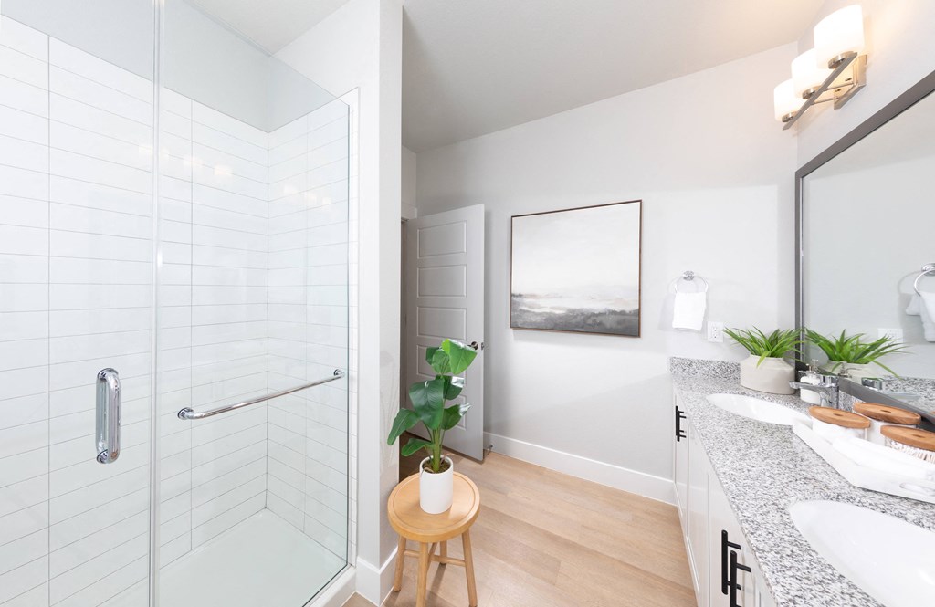 a bathroom with a shower and a sink and a mirror