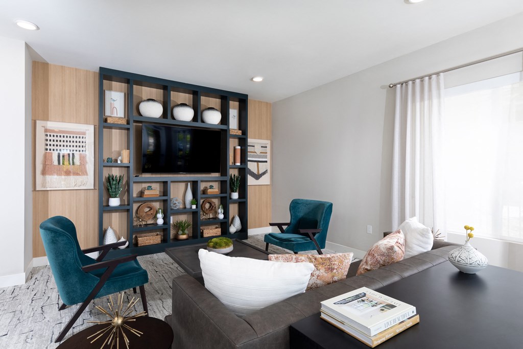 a living room with a couch and chairs and a television