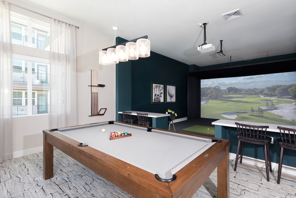 a pool table in a room with a view of a golf course