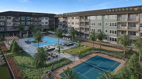 A tennis court is surrounded by a pool and palm trees in front of apartment buildings.