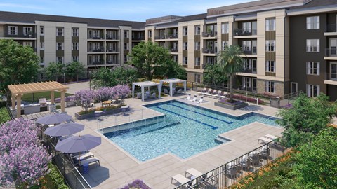 A swimming pool surrounded by apartment buildings and lush greenery.