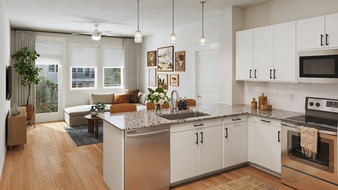A modern kitchen with white cabinets and a large island.