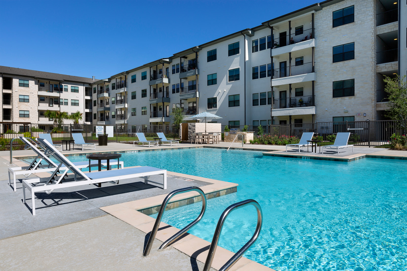 Poolside seating at Solea Cedar Park Senior Apartments in Cedar Park Texas