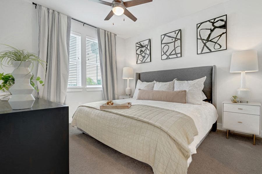 a bedroom with a bed and a ceiling fan