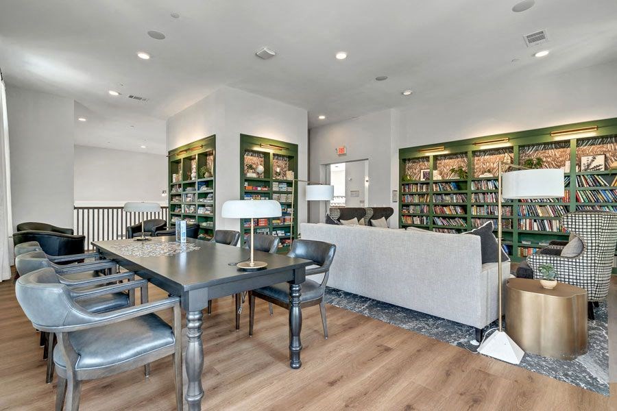a library with sitting areas at a senior apartment community