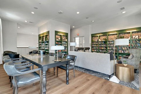 a library with sitting areas at a senior apartment community