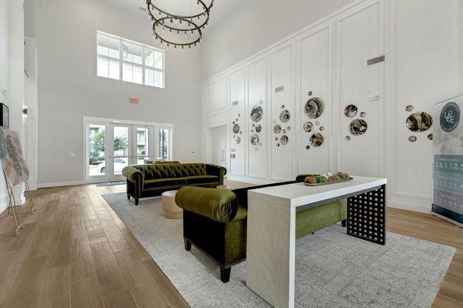 a large lobby with a chandelier and sitting area at a senior apartment community