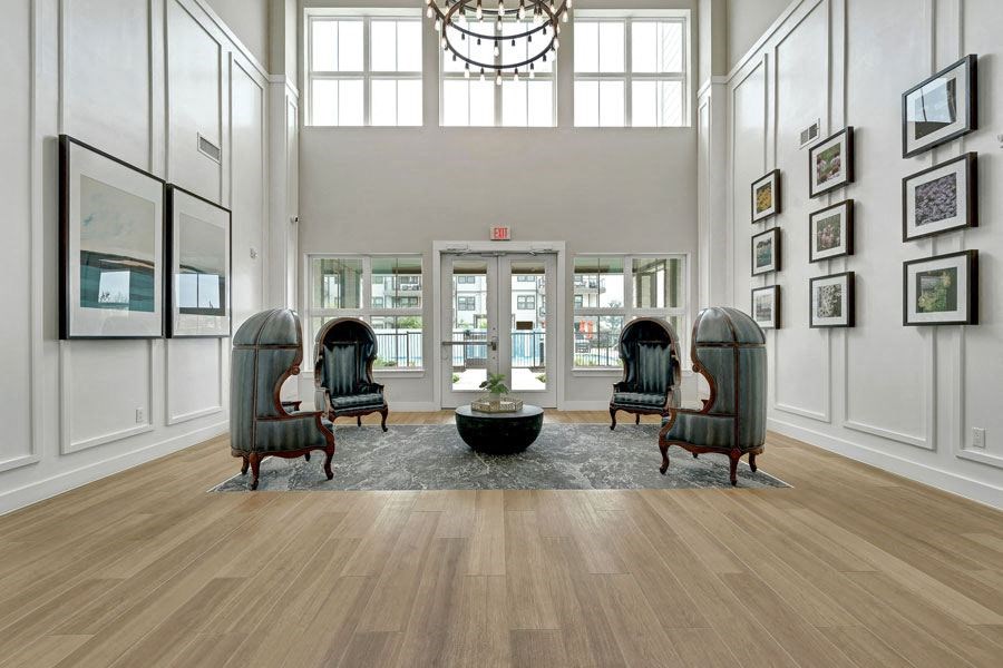 a large lobby with a chandelier and sitting area at a senior apartment community
