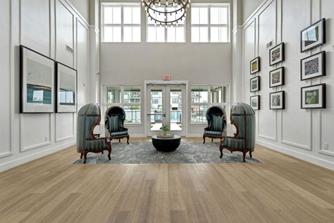 a large lobby with a chandelier and sitting area at a senior apartment community