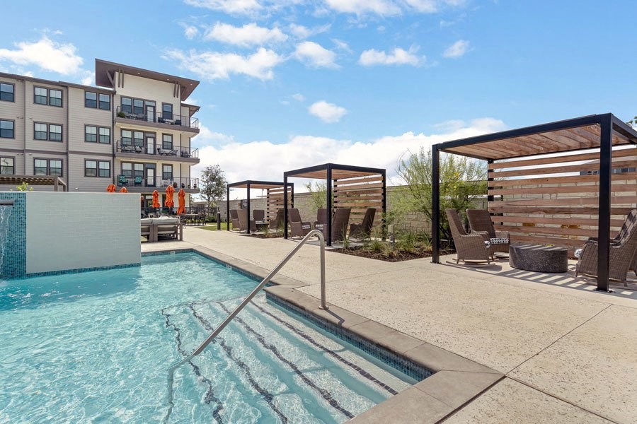 a swimming pool with a building in the background