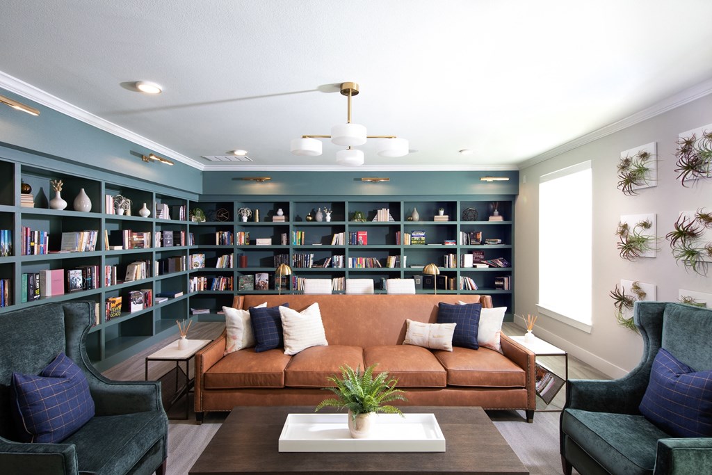 a living room with a couch and a bookshelf