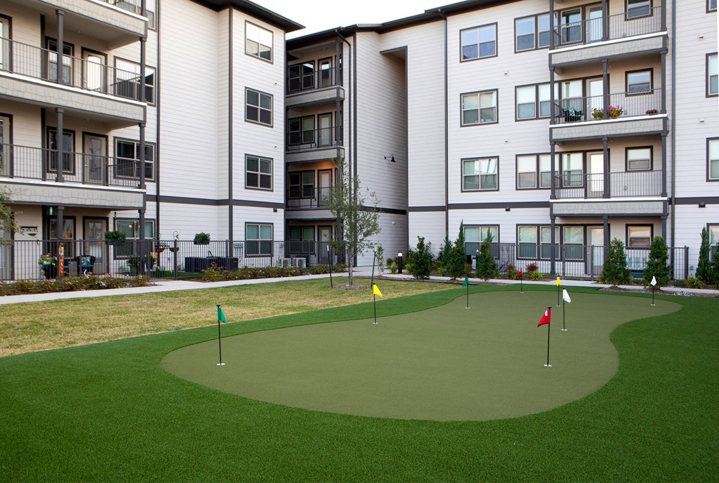a mini golf course in front of an apartment building