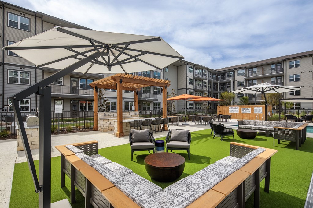 a rendering of a courtyard with tables and chairs and umbrellas