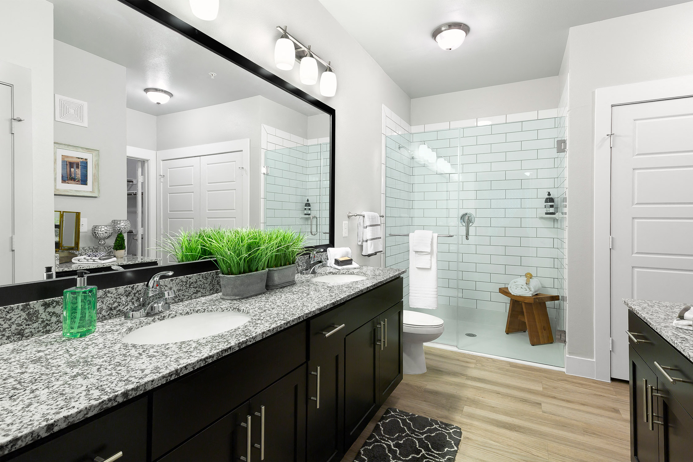 Spa like showers with framed mirrors at Cedar Park Senior Apartments in Cedar Park Texas