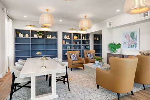 A modern dining room with a white table and chairs.