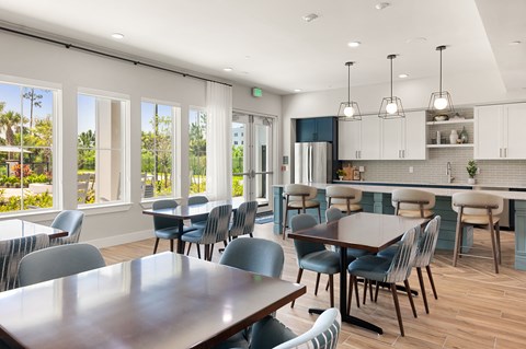 A modern kitchen and dining area with a large table and chairs.
