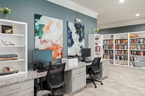 A home office with a desk, chairs, and a bookshelf.