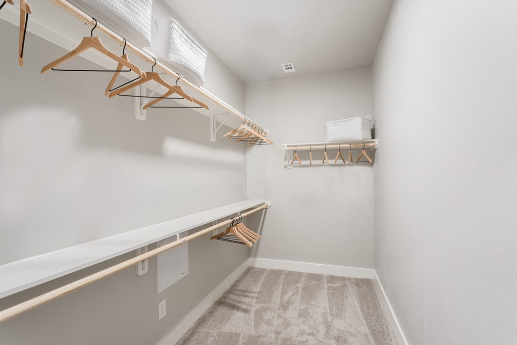a walk-in closet with shelving at a senior apartment community