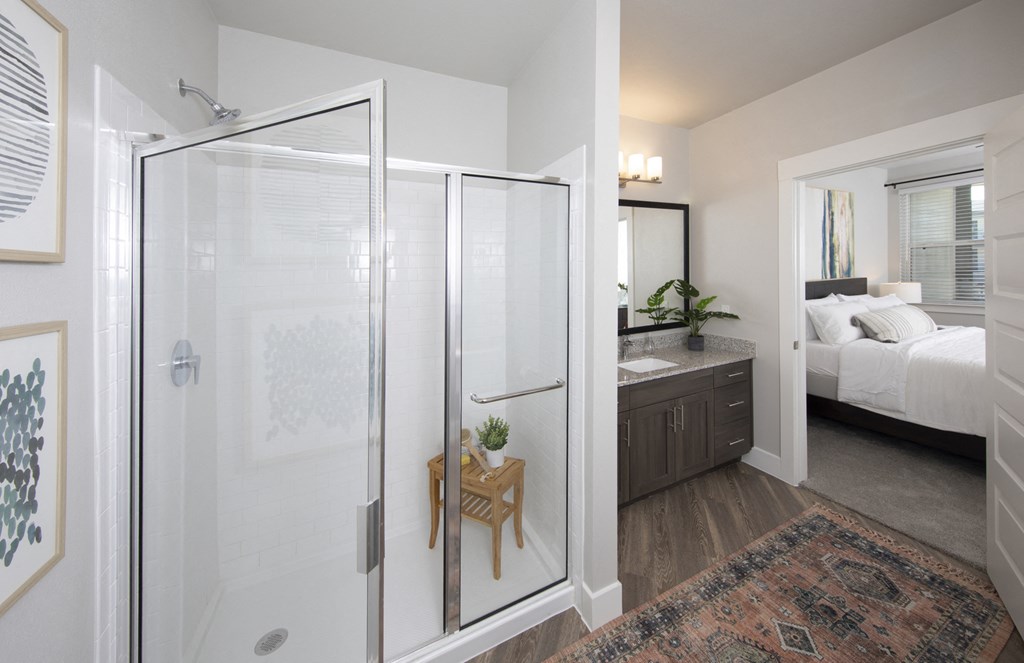 a bathroom with a glass shower at a senior apartment community