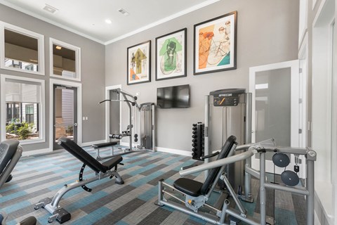 a gym with fitness machines at a senior apartment community