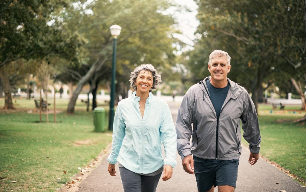 a man and woman walking in the park