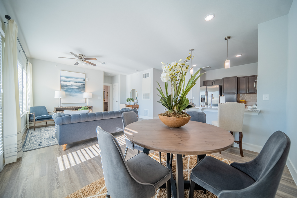 a living room with a dining room table and chairs