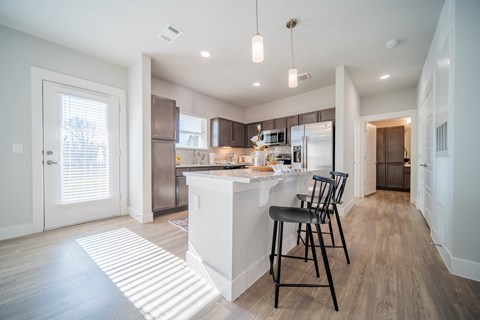 a kitchen with stainless steel appliances and granite countertops
