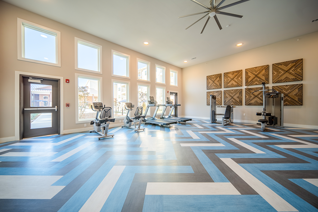 the gym at the district at highland village apartments