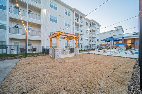 a covered outdoor grilling station at a senior apartment community