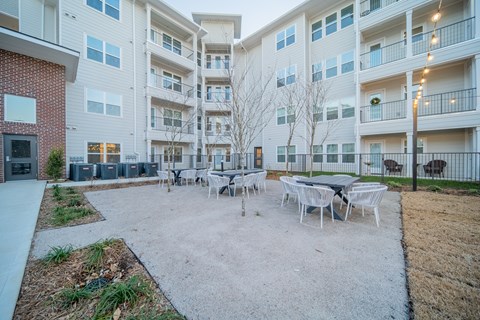 an outdoor patio with sitting areas at a senior apartment community
