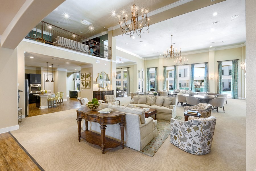 a living room with couches and chairs and a chandelier