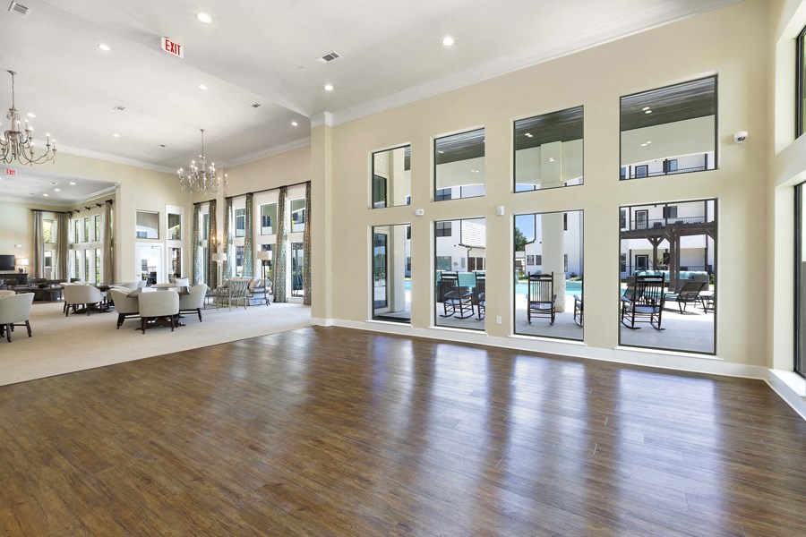 the preserve at gateway living room with wood flooring and large windows
