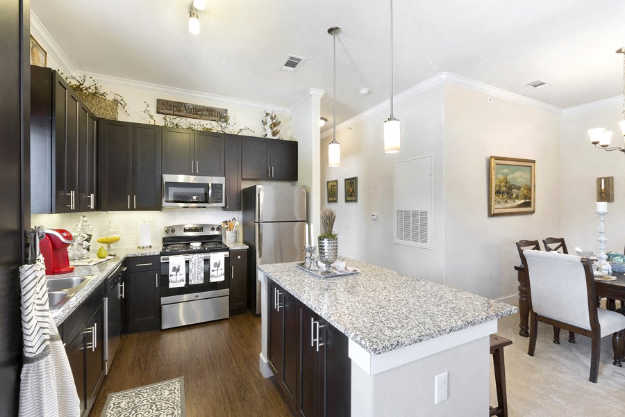 a kitchen with stainless steel appliances and granite counter tops